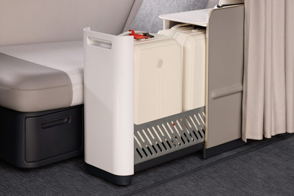 Espace de rangement élégant avec deux valises claires dans la cabine La Première d'Air France.