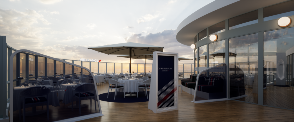 Terrasse du restaurant Air France avec tables dressées, parasols et vue sur le coucher du soleil.