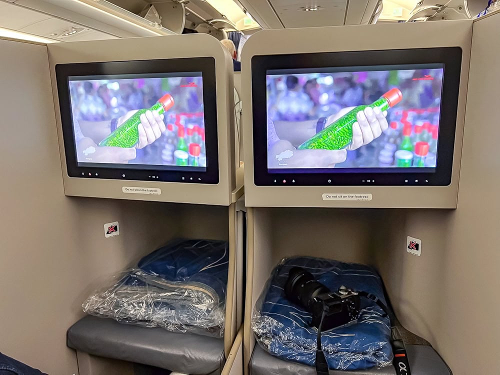 Écrans individuels en classe affaires d'un Airbus A330 d'Air Mauritius avec couvertures et oreillers.