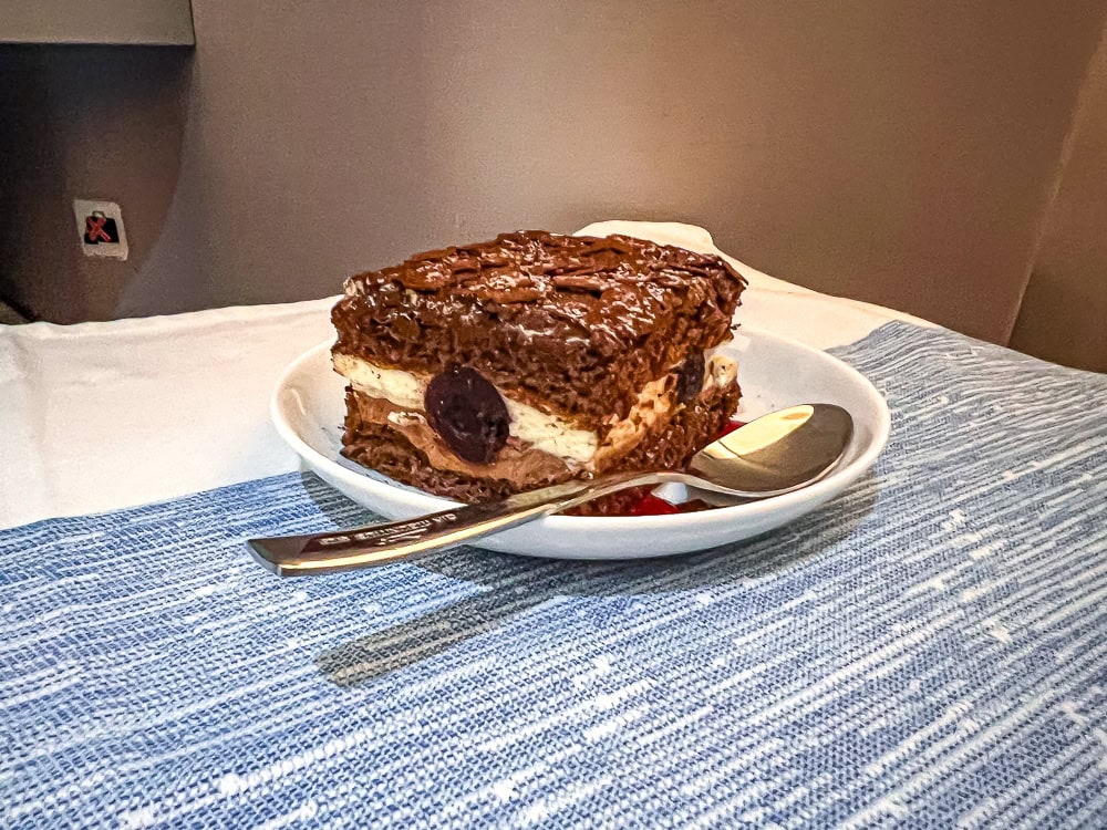Dessert au chocolat servi à bord d'un vol Air Mauritius en cabine affaires sur nappe bleue.