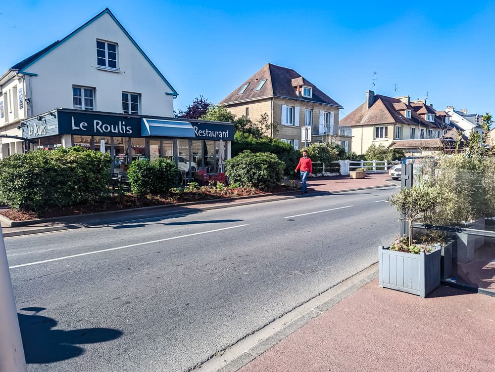 Façade du restaurant Le Roulis à Ouistreham, vue depuis la rue sous un ciel bleu clair